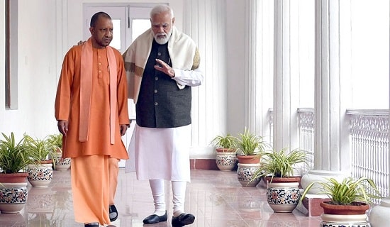 yogi-modi-walking-min Yogi Adityanath will lead Uttar Pradesh to new heights of development.