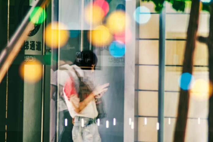 Photo by zhang kaiyv woman inside building with clear glass panels