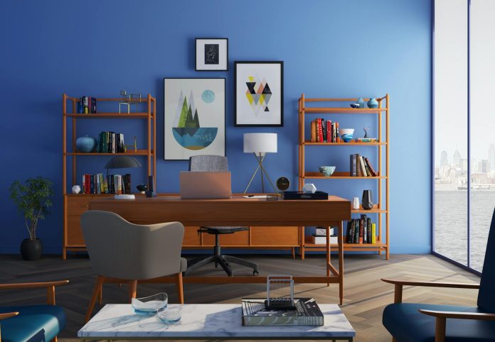 Photo by Huseyn Kamaladdin Elegantly decorated home office with modern furniture and a blue wall.